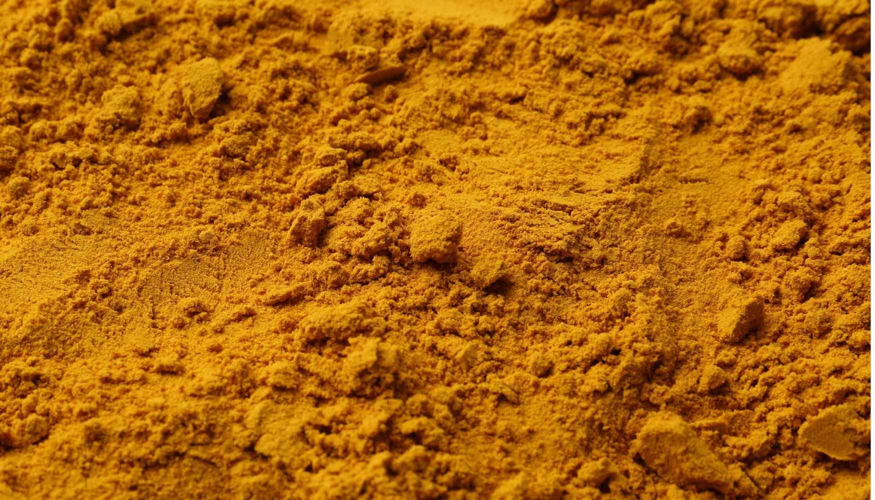 Close-up of yellow gold powder with a textured surface